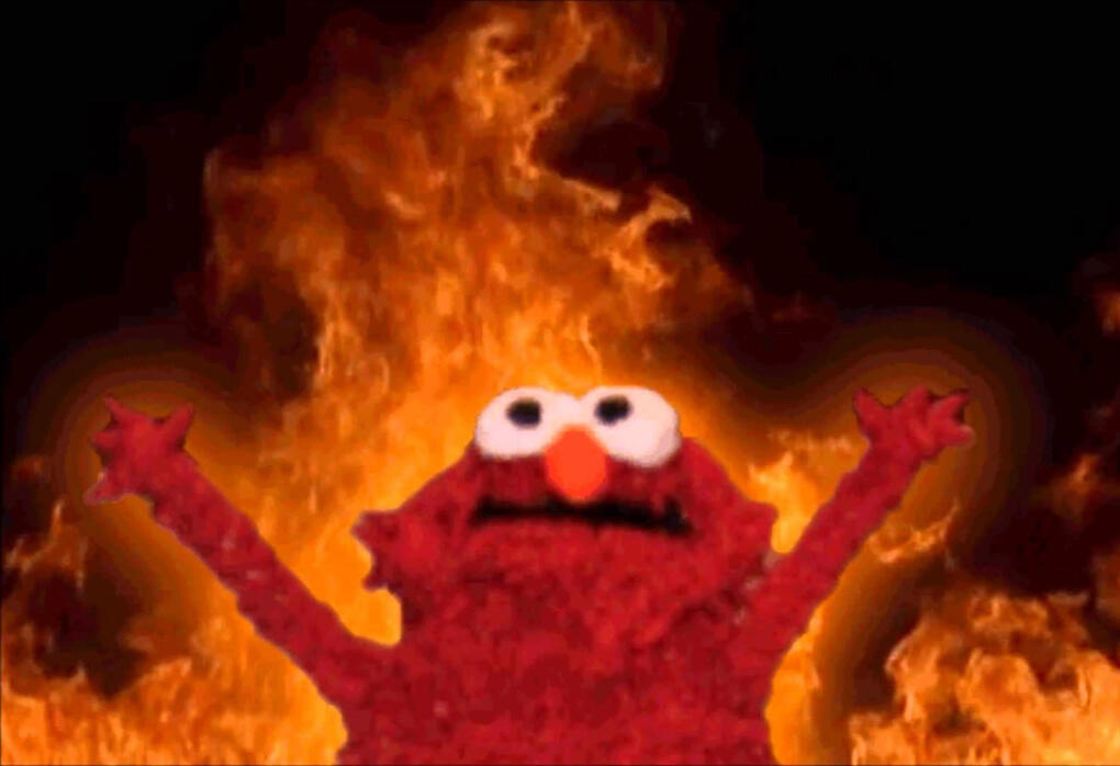 elmo raising his arms while fire burns in the background meme